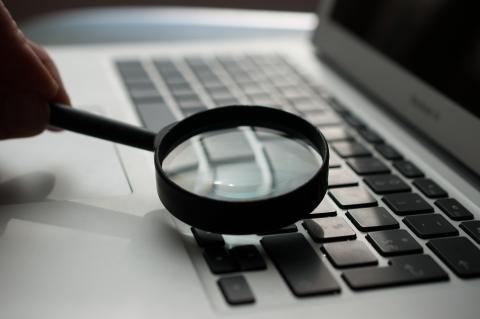 A magnifying glass being held to a laptop's keyboard. Source: http://unsplash-com-s.njmu.s5.bt8.net/photos/d9ILr-dbEdg